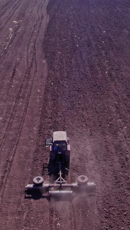 tractor tilling center of farm field in the fall