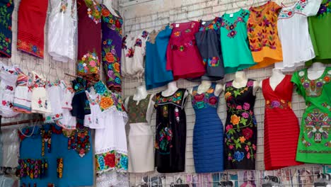 camera panning left showing colorful designer huipil blouses indigenous to merida, yucatan, mexico