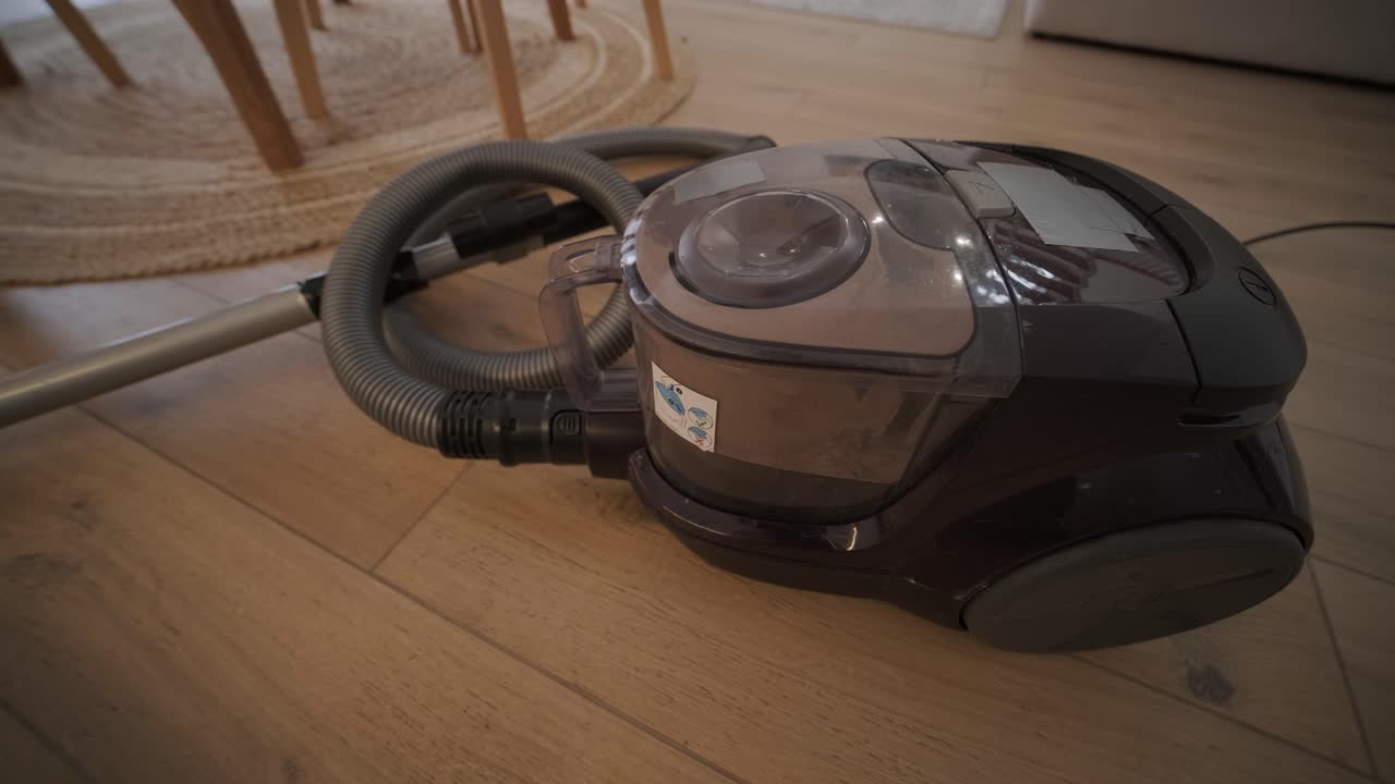 Vacuum Cleaner Running on a Wooden Floor