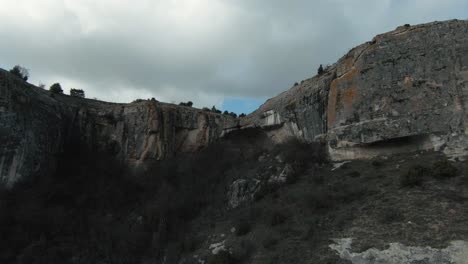 rocky canyon with cave and arch