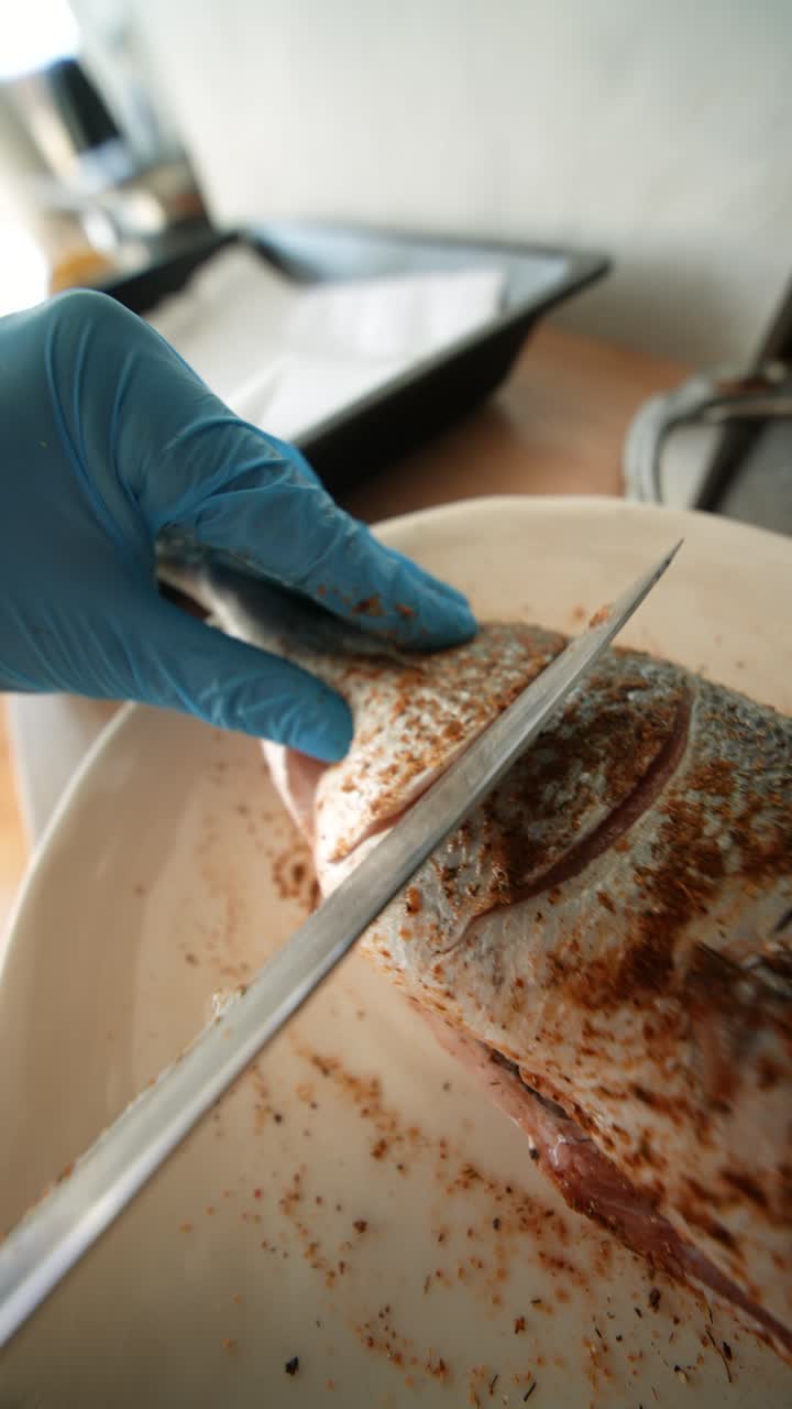 Hands in Blue Gloves Scoring Seasoned Fish for Cooking