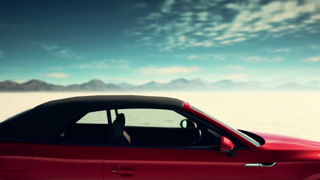 red convertible car in a desert landscape