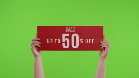 sale up to 50 percent off advertisement inscription on paper sheet in womans hands on chroma key