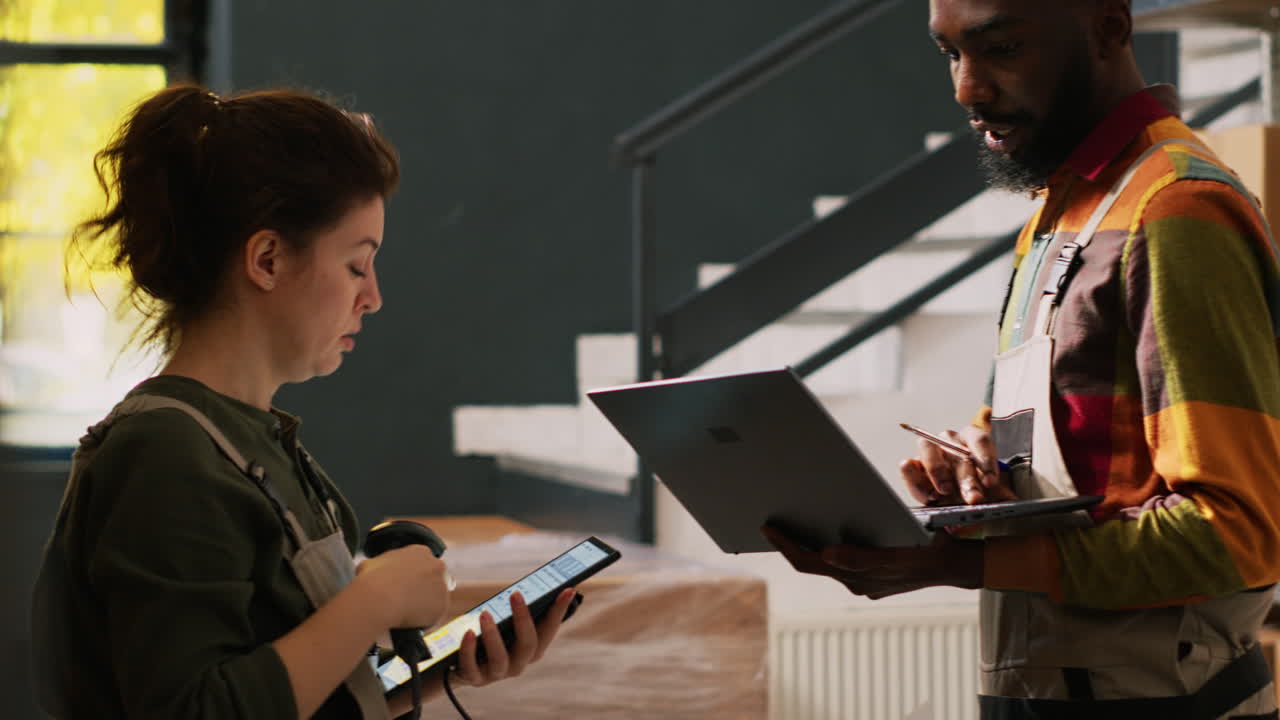 Warehouse workers scanning packages for delivery