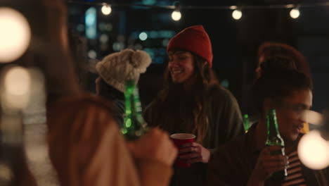 happy group of friends dancing to lively rooftop party music enjoying weekend celebration in urban city at night