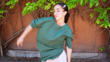 Woman in front of wall with leaves