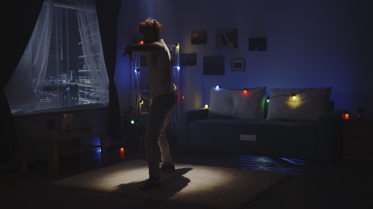 Man Dancing in a Cozy Nighttime Bedroom