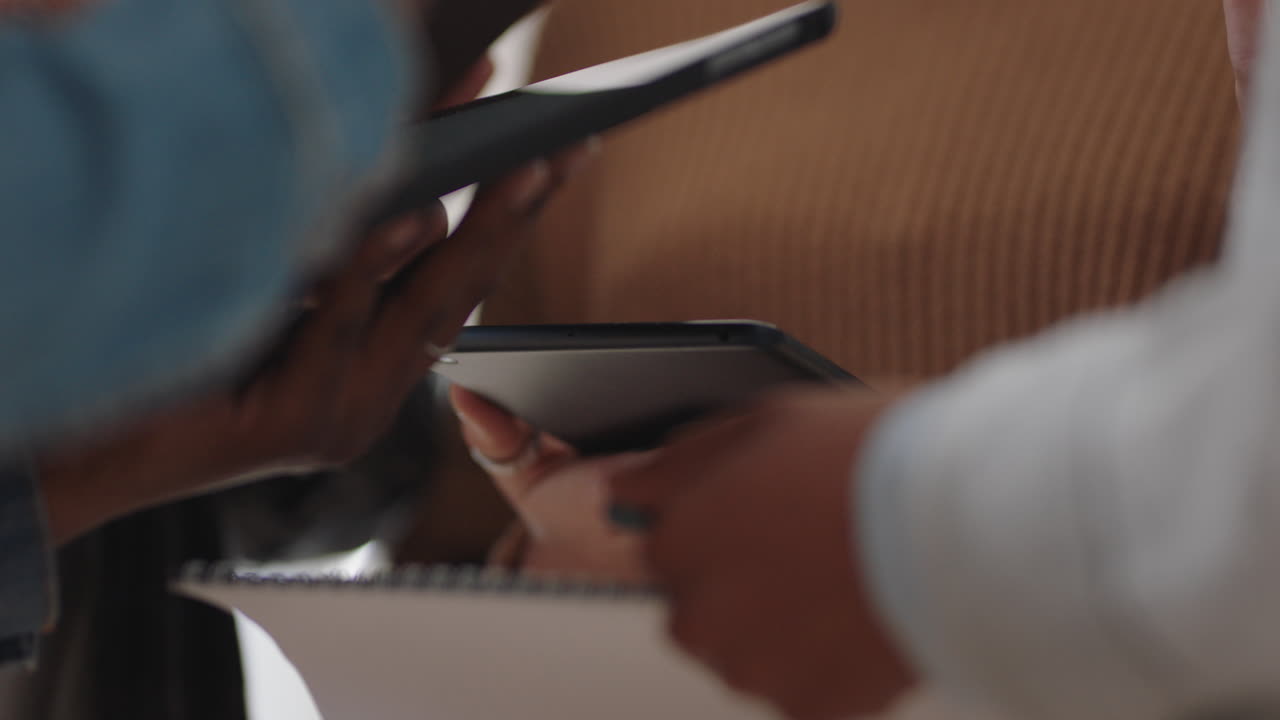 close up hands using digital tablet computers creative business people meeting sharing data brainstorming ideas for project enjoying teamwork in startup office