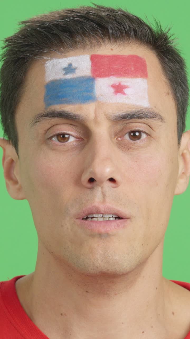 Man with a panamanian flag painted on the face smiling