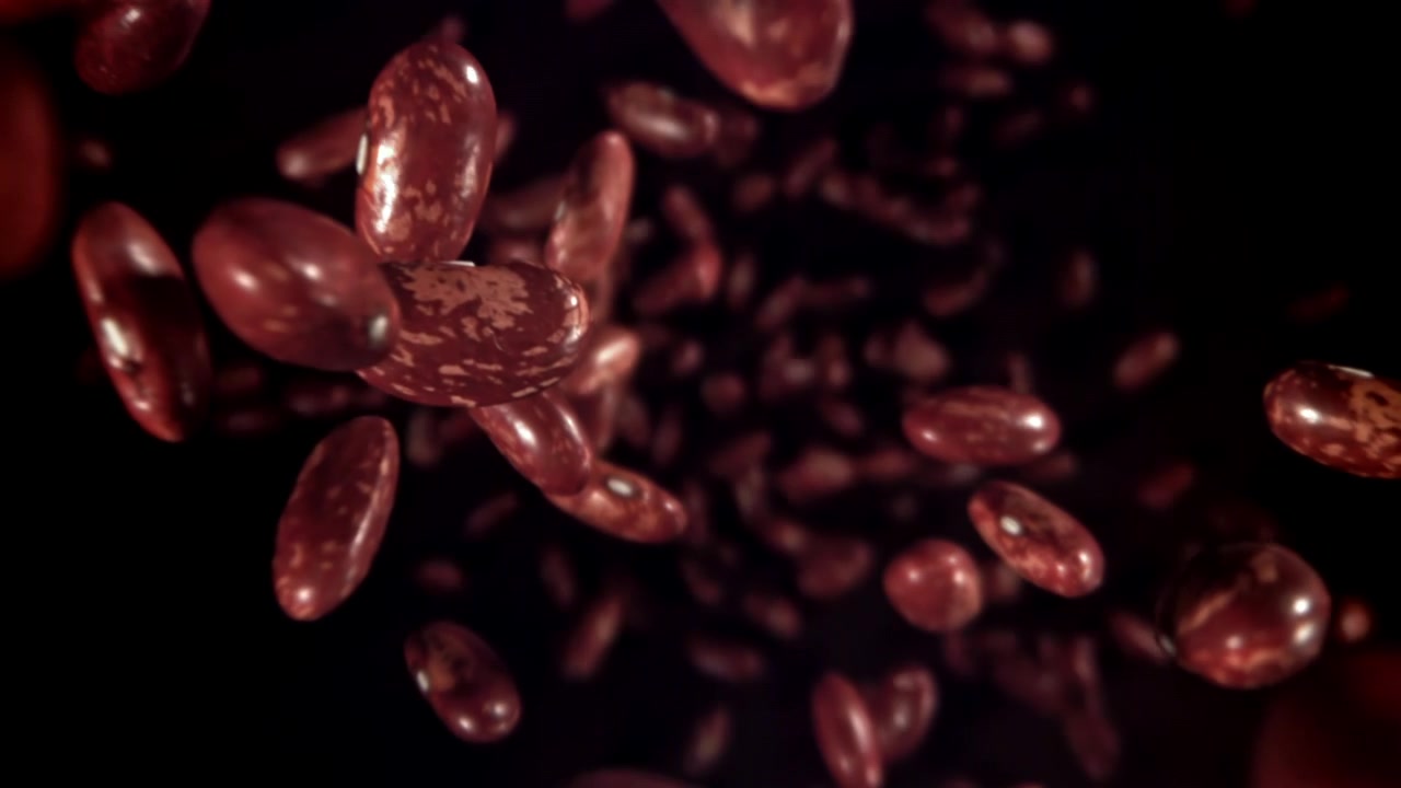 Red Kidney Beans Falling in Slow Motion on a Dark Background