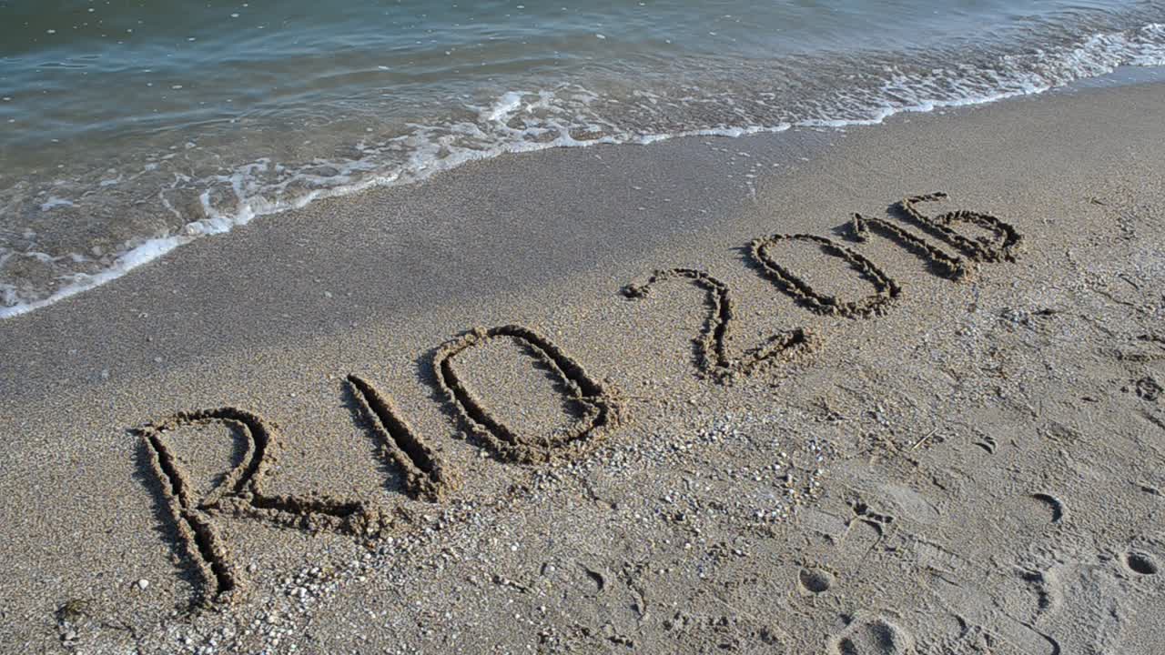 Rio 2016 an inscription on sand, the beach. Symbol Olympic game on sand, the beach