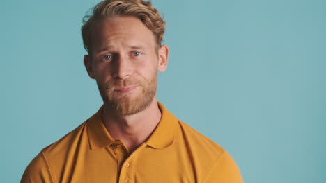 bored and nervous guy wearing yellow polo t-shirt