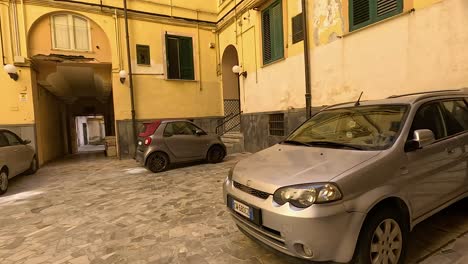 cars parked in a historic courtyard