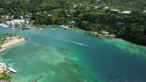 aerial view of a boat slowly cruising in marigot bay, a beautiful hidden gem in st