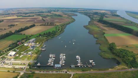 top view of drone flying around marina in blotnik, pomeranian, poland with yachts in the background