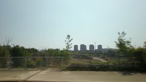 passenger point of view in a bus, riding in the outskirts of a city