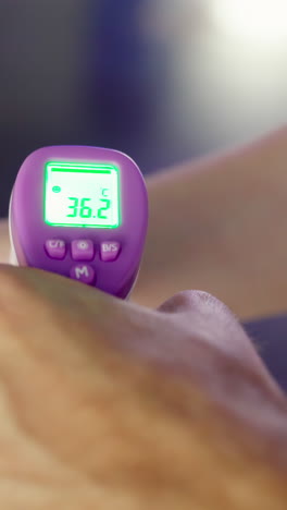 taking body temperature with a non-contact thermometer