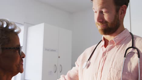 doctor examining a senior woman in a retirement home