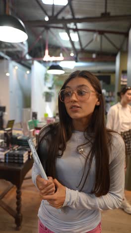 young woman browsing books in a bookstore