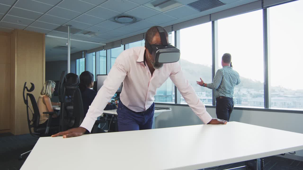 African American businessman wearing VR headset in modern office