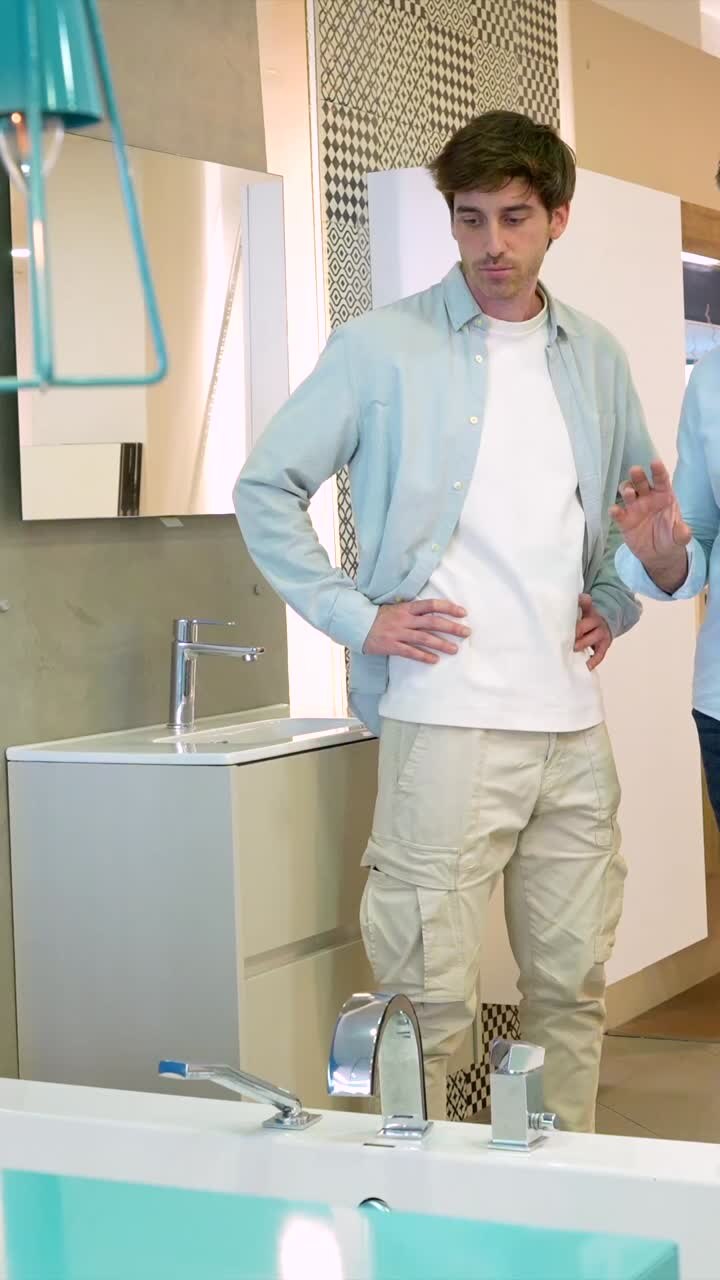 Two men looking at a bathroom sink