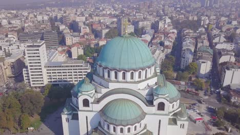 Saint-Sava-Temple-dome-and-golden-cross-in-Belgrade-city-centre,-aerial-4k