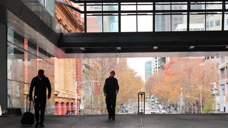 people walking through a melbourne train station