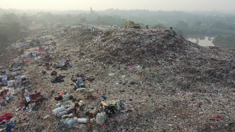 massive landfill with machinery and workers