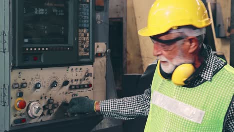 senior factory worker teach how to use machine equipment in the factory workshop