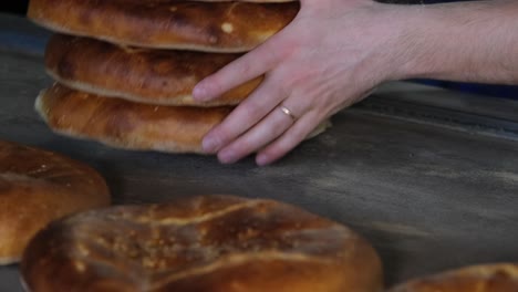 the baker collects the sesame pita fresh from the oven