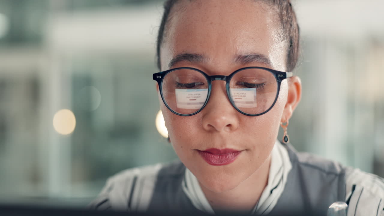 Portrait of a woman with glasses working on a computer