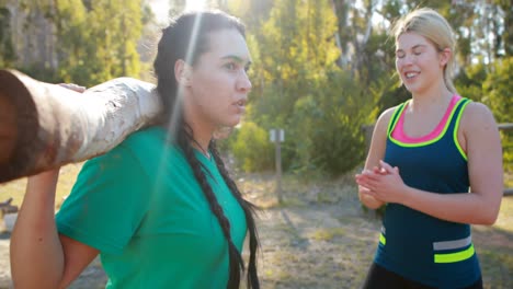 trainer assisting woman in exercising