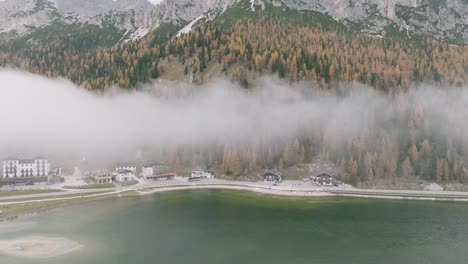 drone flight shows the shore and the asphalt road next to the misurina lake in the dolomites of south tyrol