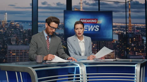 presenters lighting breaking news in late tv studio closeup. anchors discussing