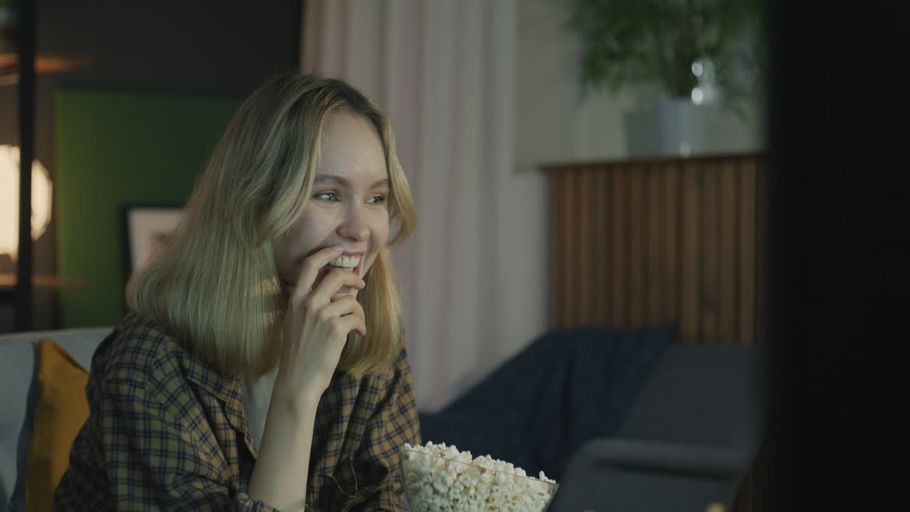 Woman Watching TV and Eating Popcorn