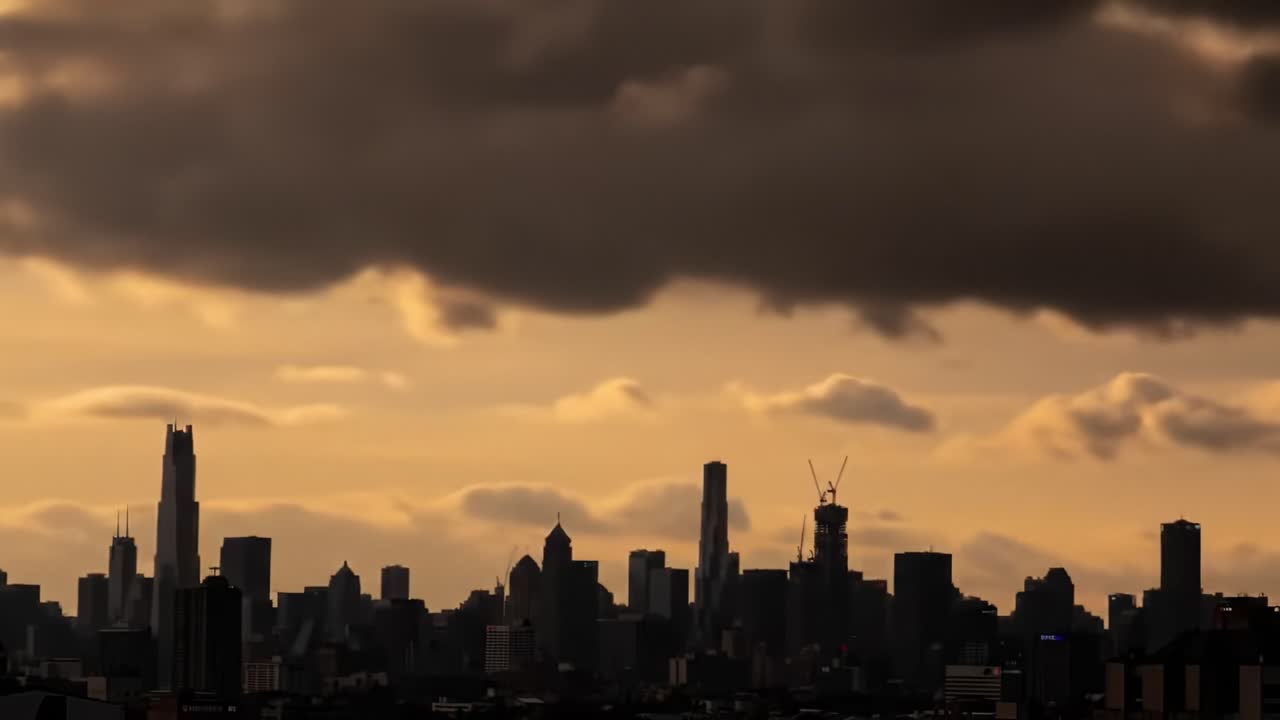 Dramatic Urban Skyline at Dusk: A Captivating View of Tall Buildings Silhouetted Against a Cloudy Sky with Golden Hues Adding a Touch of Serenity to the City Scene