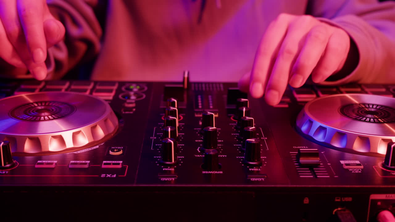 DJ with headphones and sunglasses playing music on festival in night club. Techno musician performing at nightclub for concert crowd of people, city bar.