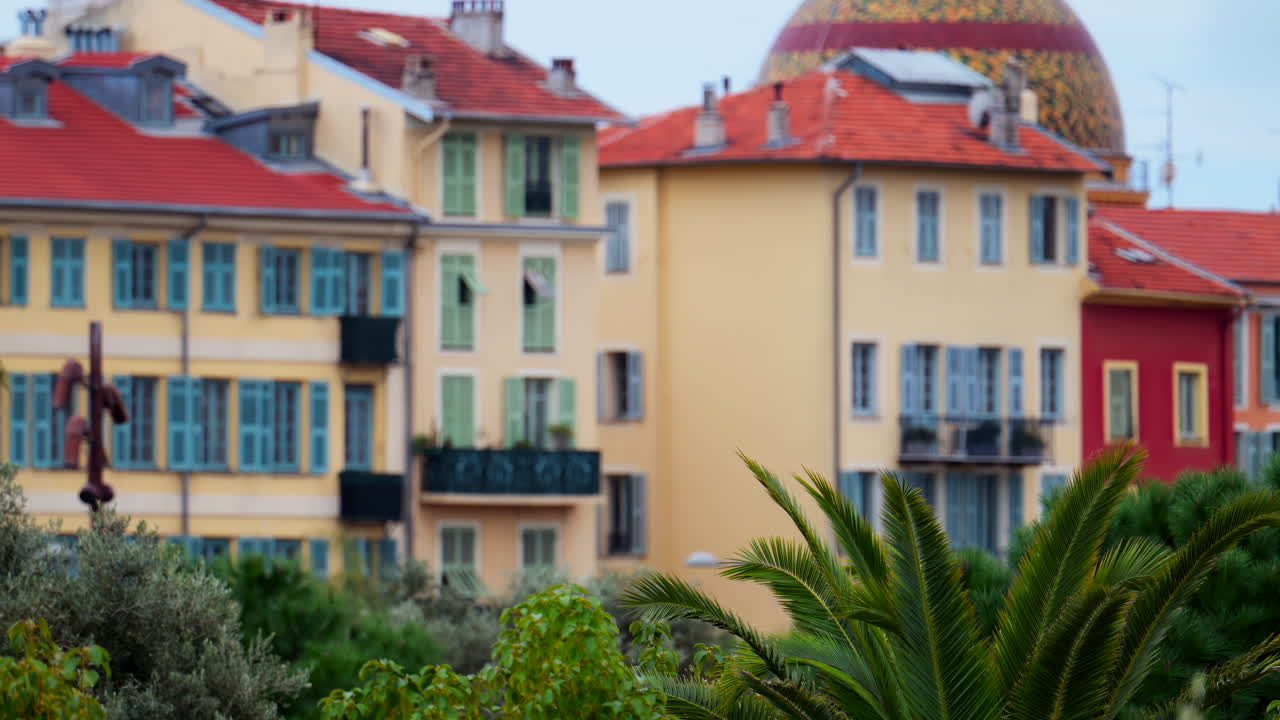 Colourful buildings and trees in the skyline of Nice, France on a cloudy day