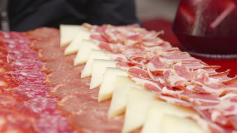 cheese and cold meat platter served on the table. - close up