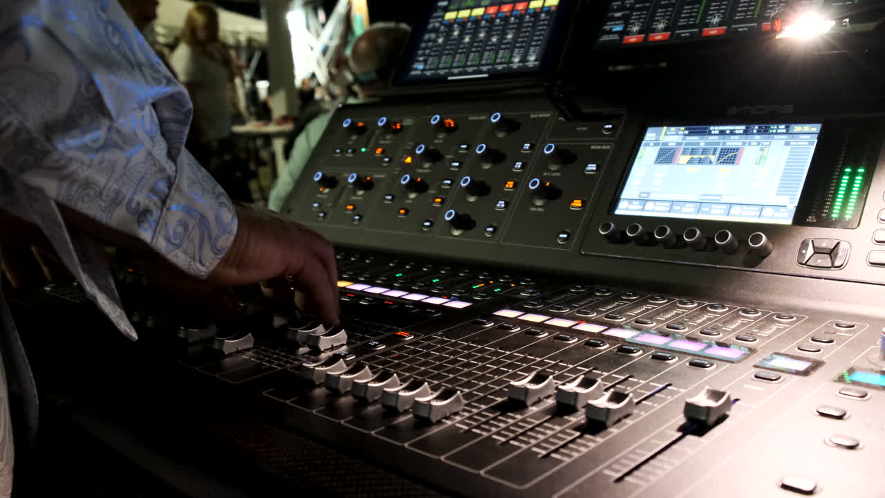 Audio board at an outdoor concert at night