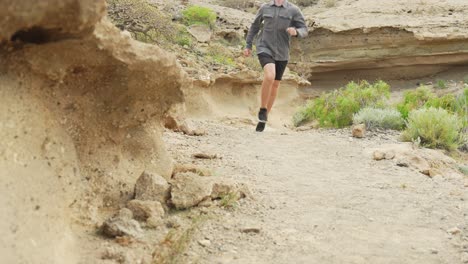 young man jogging in harh landscape of acro de tajao in tenerife