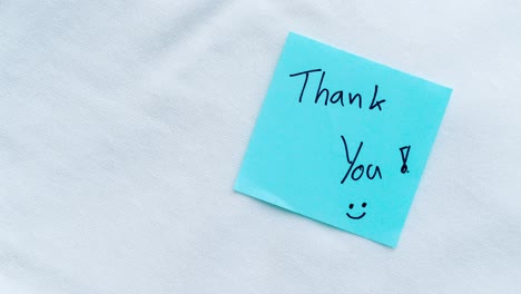 a close-up view of a blue sticky note with a heartfelt message of gratitude emphasizing appreciation and simplicity.