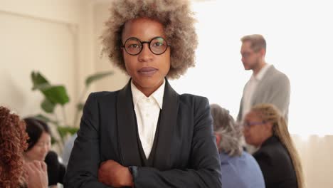 african business woman smiling on camera while working with colleagues inside bank office