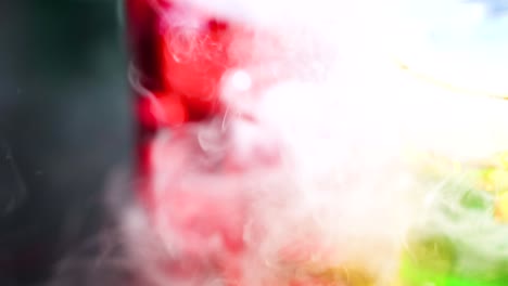 vibrant liquids reacting with smoke in beakers