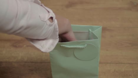 woman looking inside a gift bag