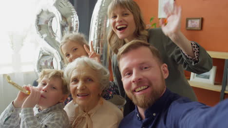 pov of happy family taking selfie on grandma birthday dinner