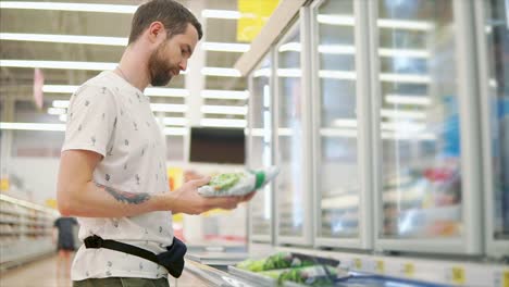 man shopping for frozen vegetables