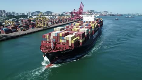 a container ship navigates through a busy port amidst towering cranes and vibrant cargo lines, showcasing the vibrancy of maritime trade and logistics