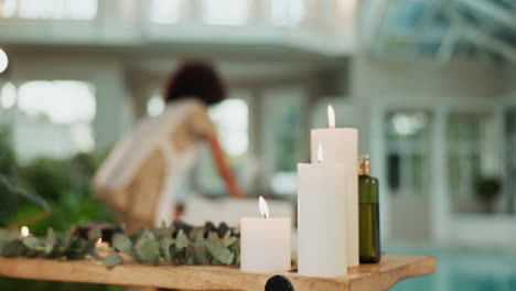 candles and eucalyptus on a wooden table