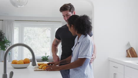 Loving-Couple-Wearing-Pyjamas-Having-Romantic-Dance-In-Kitchen-At-Home-Together